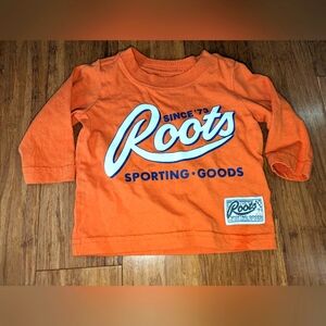 Roots baby gender neutral orange long sleeve shirt.